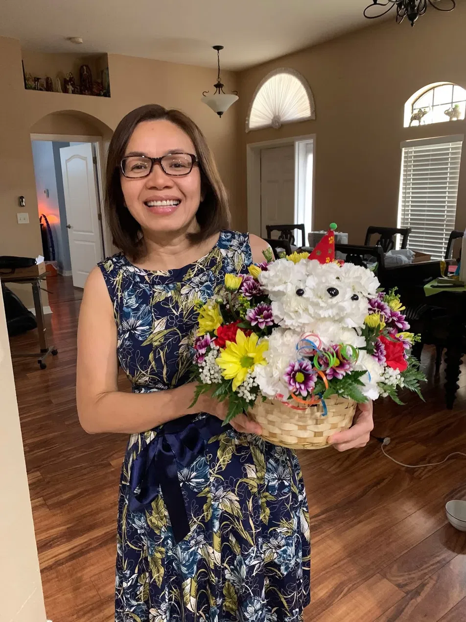 Grace at home, holding a flower bouquet